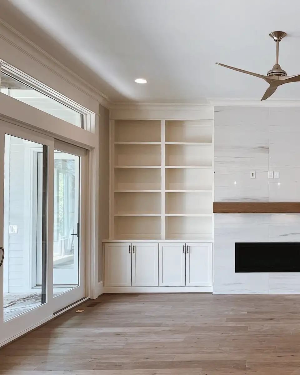 Living room with built-in shelving either side of the fireplace